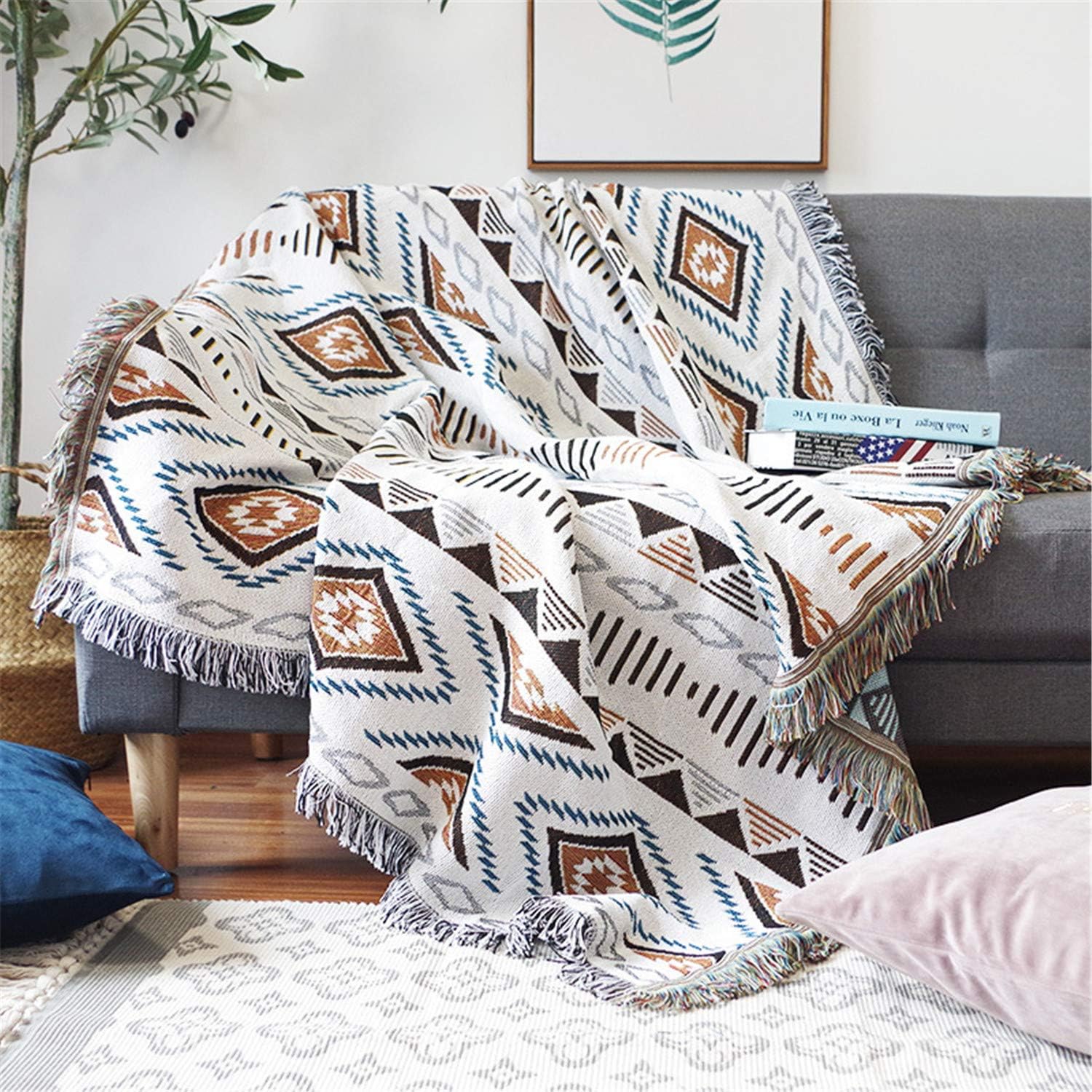 Aztec pattern woven throw blanket draped over a chair