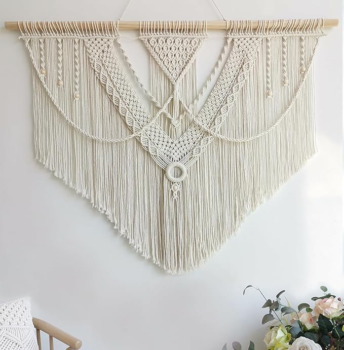 Large macrame wall hanging behind a desk setup